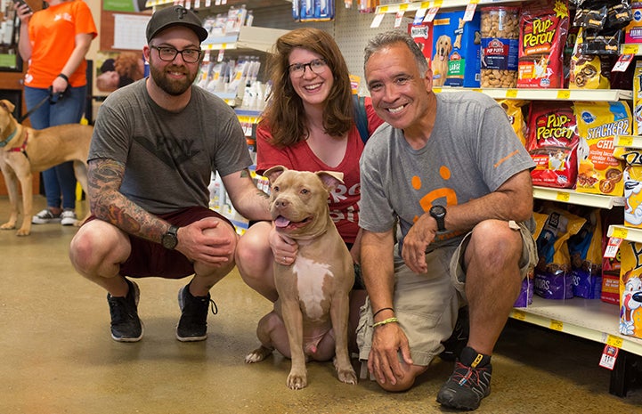 Porkchop the dog poses with volunteer Peter Vega and friends