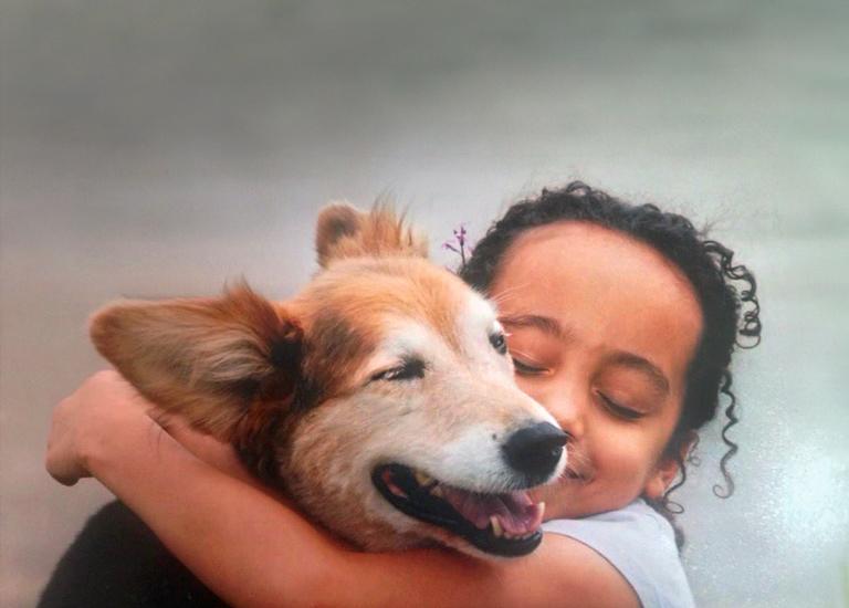 Sophie hugging her dog