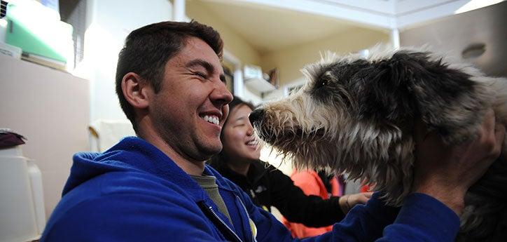 Man scrunching up his face after smelling a stinky dog