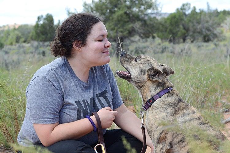 Woman teaching a dog to speak (bark)