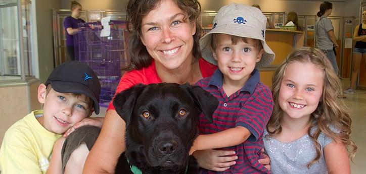 family adopting a pet posing together with their new dog