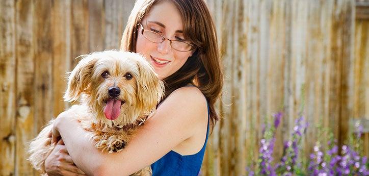 woman holding her dog she rescued from an animal shelter 