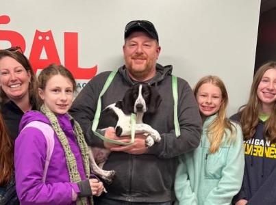 Vixen the dog being adopted by a family from RAL