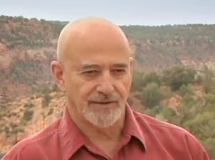 Man speaking with canyon in background