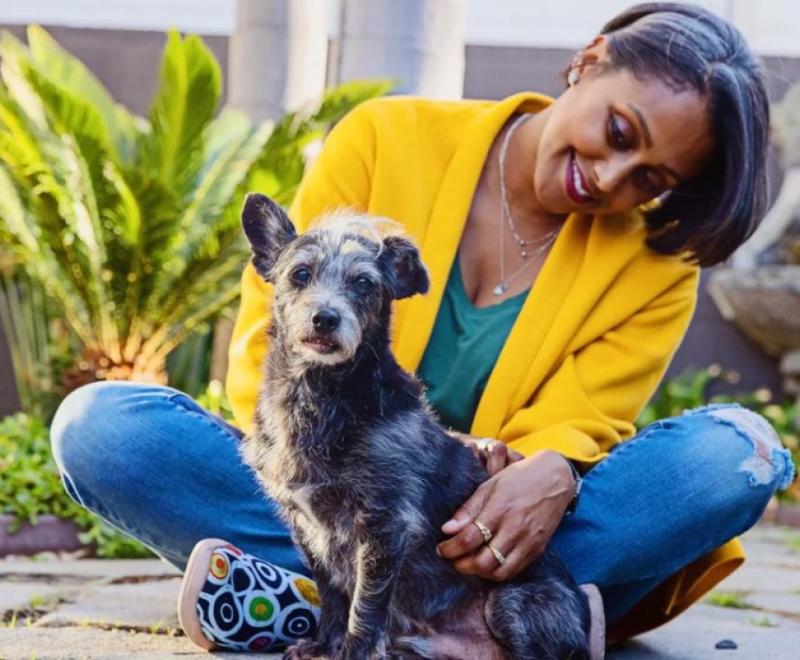 woman smiling with a dog