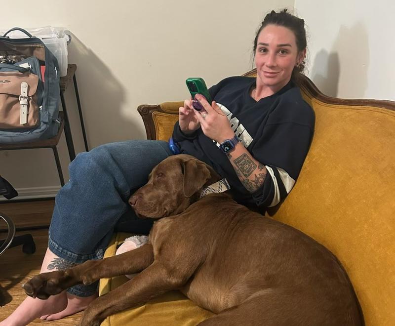 Erin and Spud the dog on the couch together