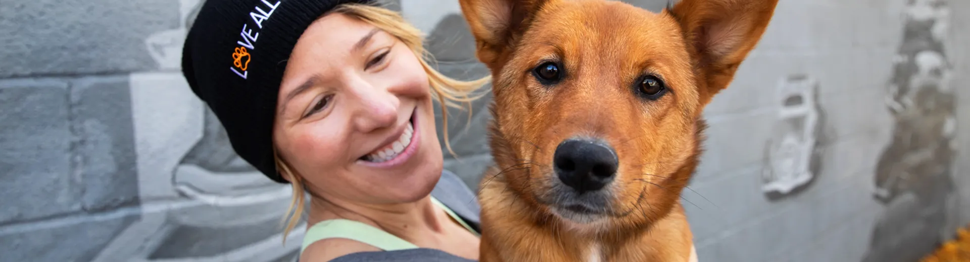 Smiling person holding a dog