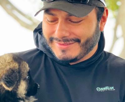 Smiling man holding a puppy