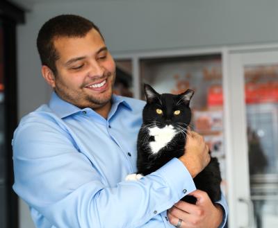 Smiling person holding a cat