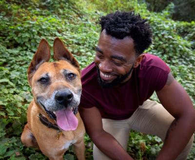 Person sitting outside with dog