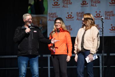 Julie with two other people on the stage at Strut Your Mutt