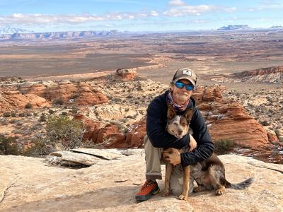 J.J. with Whitey the dog in front of a beautiful red rocks vista