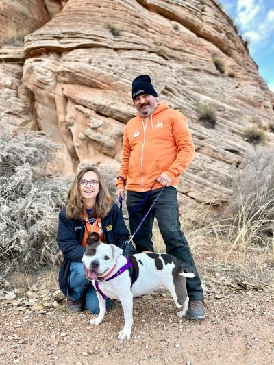 Jason and Kim outside with Bella the dog on a leash