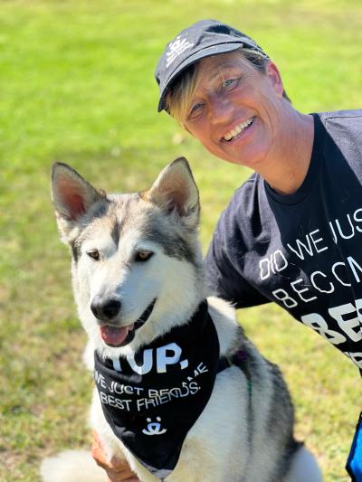 Lou and Midas the dog, wearing a matching T-shirt and bandanna