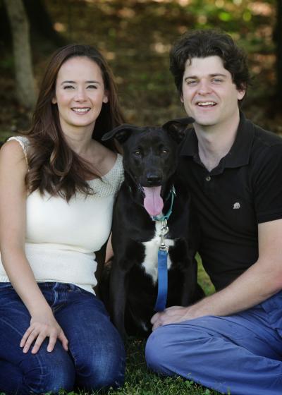 Vanessa Woods and Brian Hare with a black dog between them