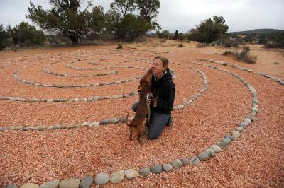 A person and dog at the labyrinth by Angels Overlook