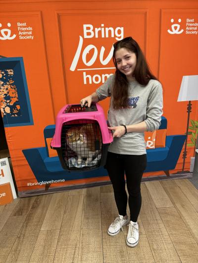 Katie adopting Goldilocks the cat, who is in a carrier