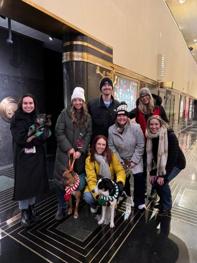 Group of people and three dogs at Rockefeller Center in New York City