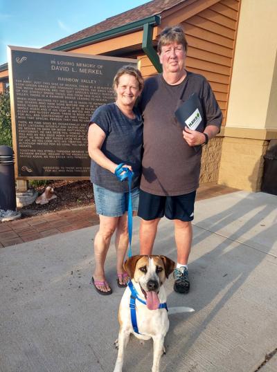 Ben the dog being adopted by Larry Russell and another person