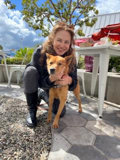 Hanjae the dog being hugged by a person outside on patio