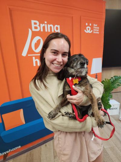 Allison holding Henry the dog when adopting him