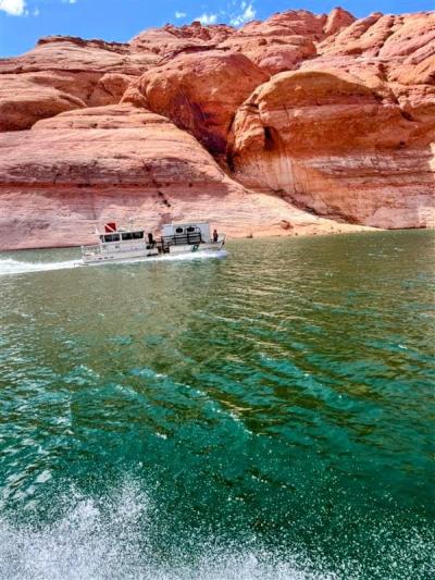 The horses rescued and and in the trailer on the boat on the lake with red rocks in the background