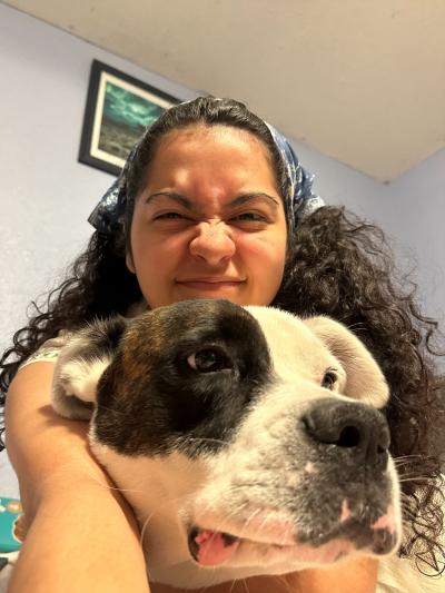 Best Friends marketing intern Jazmin Aguilar taking a selfie with a black and white dog