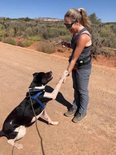 Jenny Franz shaking hand to paw with Polo the dog