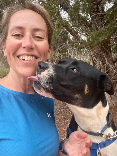 Jenny Franz being kissed on the chin by Polo the dog