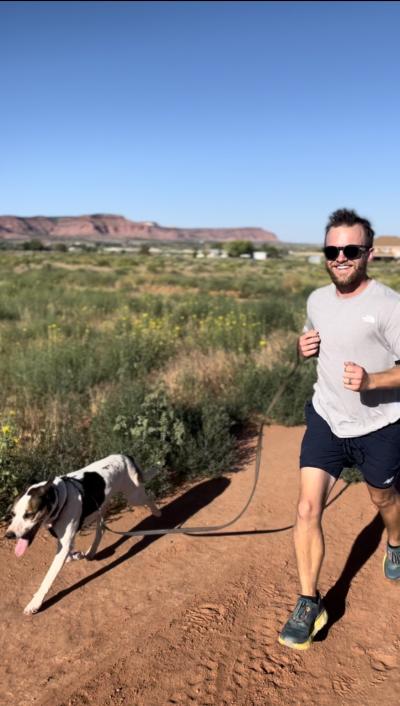 Max Hoffman running with a dog on a leash