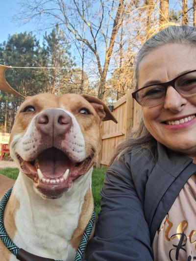 Smiling dog next to a smiling person