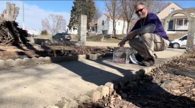 Ben Clark next to a live trap with a TNVR community cat