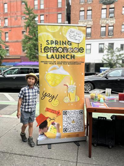 Julian standing beside his lemonade stand