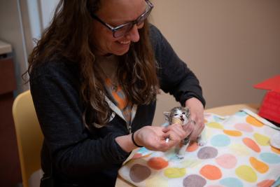 Amy syringe feeding Arabelle the kitten