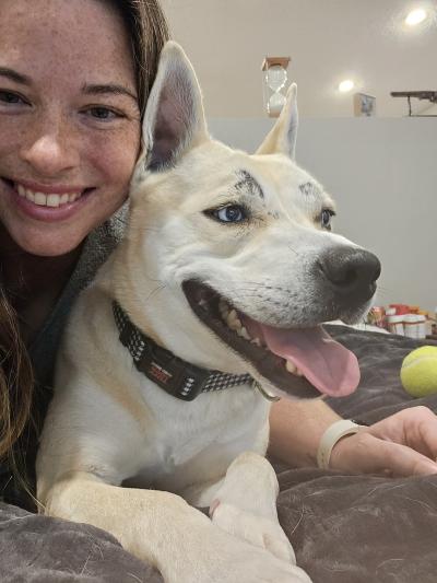 Person smiling next to Bonny the dog