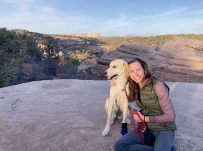 Ashley with Lacey the dog on top of a rock formation