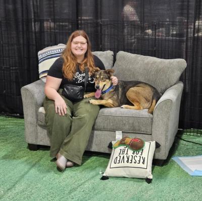 Lavender the dog being adopted, sitting on a couch together