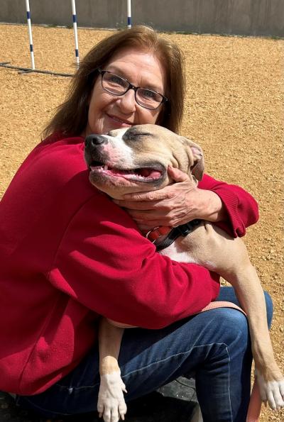 Lorie Comer hugging a dog