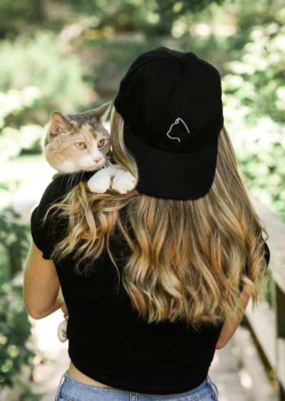 Person holding Mackenzie the cat over he shoulder