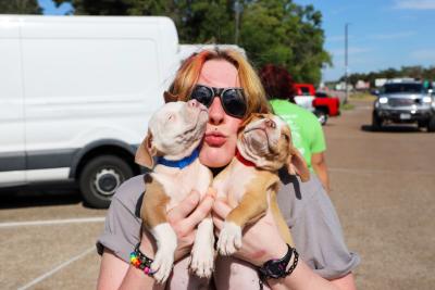 Person holding Suzette and Mousse close to her face with lips pursed in a kiss