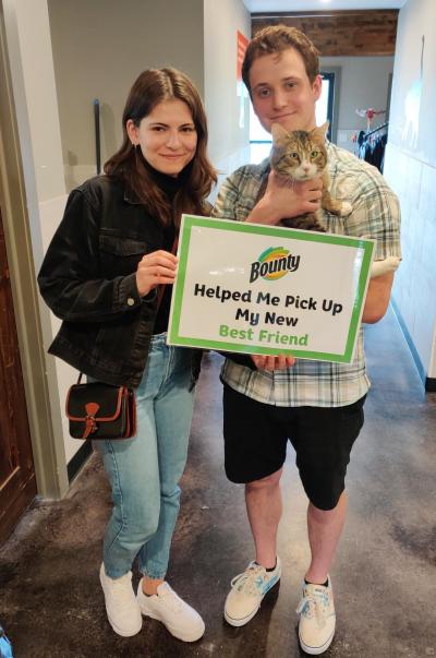 Couple holding a cat and sign at the National Adoption Weekend