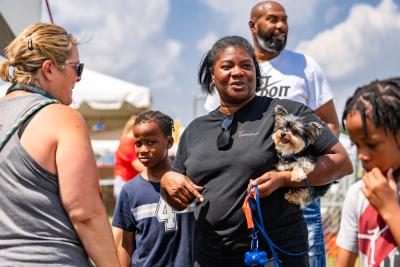 Family with a small fluffy dog at the Best Friends Super Adoption in Northwest Arkansas