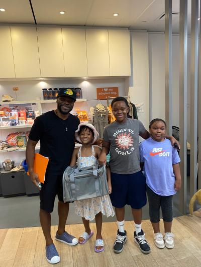 Family of four holding a carrier with their newly adopted pet from the Best Friends Lifesaving Center in New York City