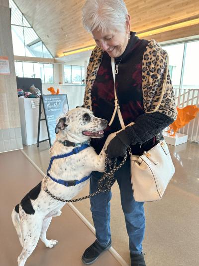 Neo the dog and Linda on adoption day with Neo standing up with his paws up on Linda's waist