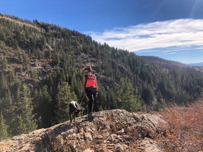 Geoffrey's wife and Pepper the dog out on a hike in what looks to be mountains