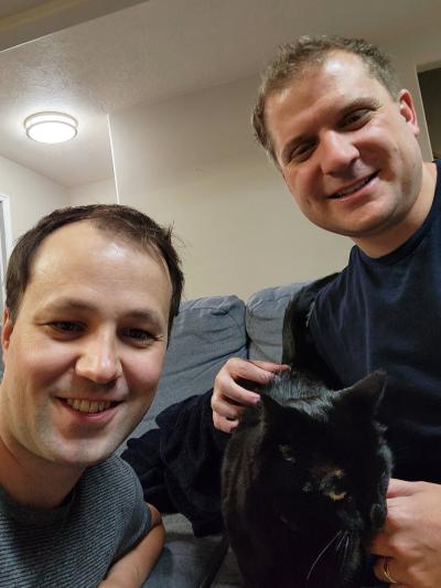 Peridot the cat with her adopters