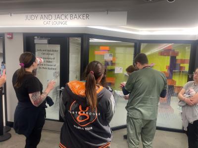 Group of people doing population rounds outside the Judy and Jack Baker Cat Lounge