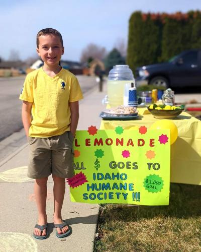 Ben Miller standing next to his lemonade stand