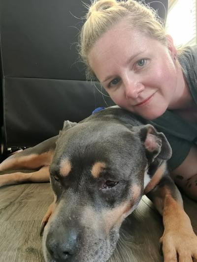 Person posing with Sage the foster dog