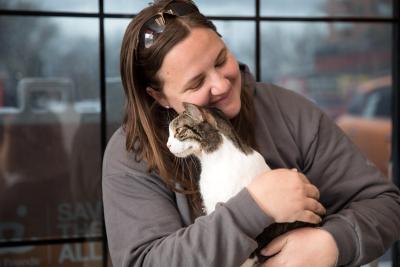 Person hugging a senior cat